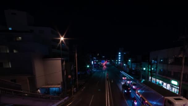 東京の街中での渋滞の夜のタイムラプスワイドショットパンニング — ストック動画