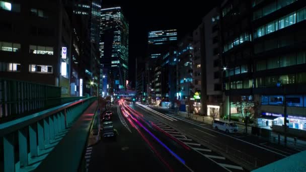 A night timelapse of the traffic jam at the urban street in Shibuya wide shot tilt — стоковое видео