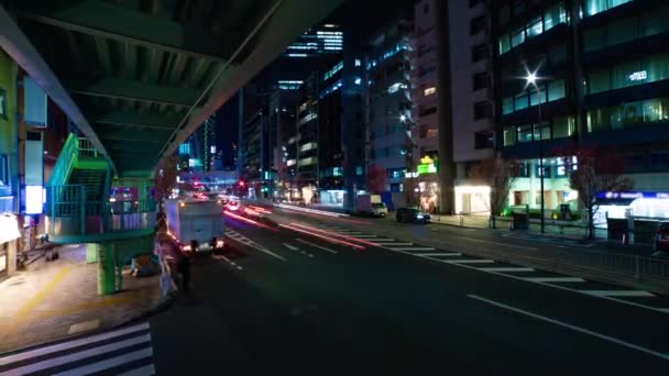 A night timelapse of the traffic jam at the urban street in Shibuya wide shot zoom — Wideo stockowe