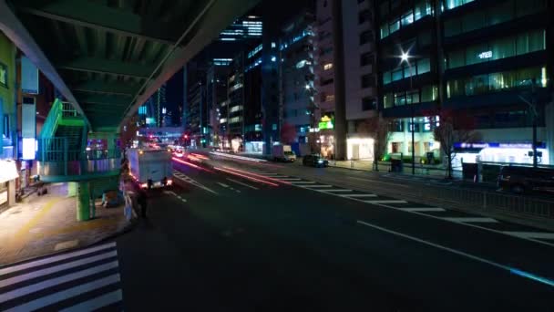A night timelapse of the traffic jam at the urban street in Shibuya wide shot tilt — Wideo stockowe