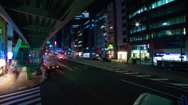 A night timelapse of the traffic jam at the urban street in Shibuya wide shot — Wideo stockowe
