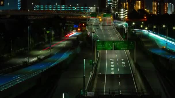 A night timelapse of the traffic jam at the urban street in Tokyo tilt — Wideo stockowe