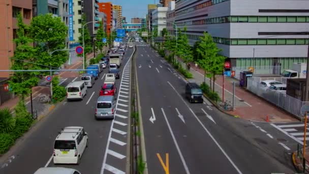 A timelapse of downtown street at Kanpachi avenue in Tokyo wide shot panning — ストック動画