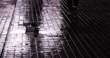 Puddle on the city street in Shinjuku at night rainy day handheld