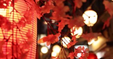 An artificial flowers of cherry bloom in Shinjuku at night handheld