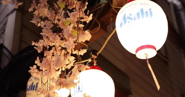 An artificial flowers of cherry bloom in Shinjuku at night handheld — ストック動画