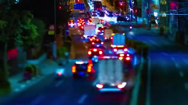 A night timelapse of the miniature traffic jam at the downtown street in Tokyo panning — Stock Video