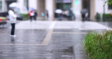 Marunouchi Tokyo 'nun yağmurlu günlerinde sokakta yürüyen insanlar. Yüksek kalite 4K görüntü. Chiyoda bölgesi Marunouchi Tokyo Japonya 05.13.2022