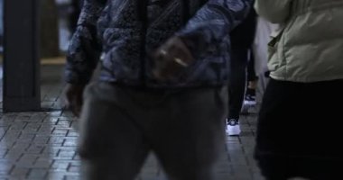 Walking people at the crossing rainy day at night. Shinjuku district Tokyo Japan - 01.09.2020 : It s legs of the people on the crossing.