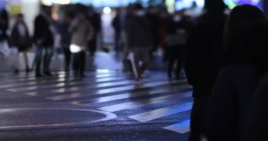 Walking people at the crossing rainy day at night. Shinjuku district Tokyo Japan - 01.09.2020 : It s legs of the people on the crossing.