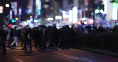 Walking people at the crossing rainy day at night. Shinjuku district Tokyo Japan - 01.09.2020 : It s legs of the people on the crossing.