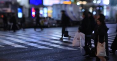 Walking people at the crossing rainy day at night. Shinjuku district Tokyo Japan - 01.09.2020 : It s legs of the people on the crossing.