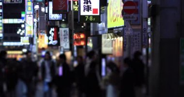 Walking people at the crossing rainy day at night. Shinjuku district Tokyo Japan - 01.09.2020 : It s legs of the people on the crossing.