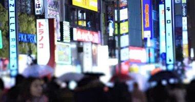 Walking people at the crossing rainy day at night. Shinjuku district Tokyo Japan - 01.09.2020 : It s legs of the people on the crossing.