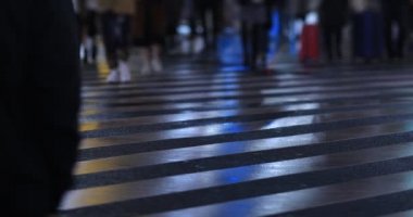Walking people at the crossing rainy day at night. Shinjuku district Tokyo Japan - 01.09.2020 : It s legs of the people on the crossing.