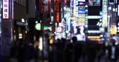 Walking people at the crossing rainy day at night. Shinjuku district Tokyo Japan - 01.09.2020 : It s legs of the people on the crossing.