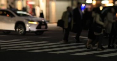 Walking people at the neon town at night long shot. Minato district Shinbashi Tokyo Japan - 01.16.2020 : It is downtown in Tokyo