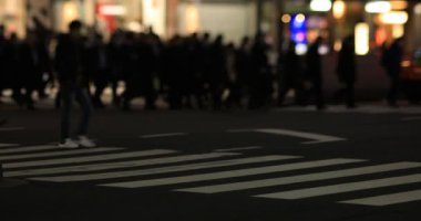 Walking people at the neon town at night long shot. Minato district Shinbashi Tokyo Japan - 01.16.2020 : It is downtown in Tokyo