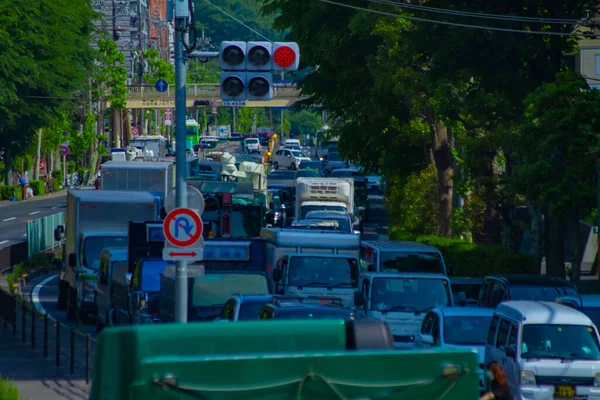 A traffic jam at the urban street in Tokyo long shot. High quality photo. Tokyo Japan 05.18.2022 Here is a downtown street in Tokyo.