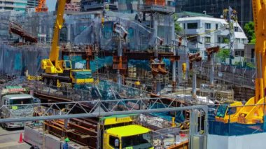 A timelapse of crane at the under construction in Tokyo long shot panning. High quality 4k footage. Minato district Azabu Tokyo Japan 06.28.2022 It is center of the city in Tokyo. 