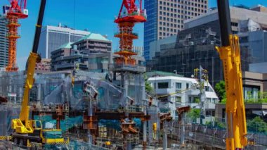 A timelapse of crane at the under construction in Tokyo long shot panning. High quality 4k footage. Minato district Azabu Tokyo Japan 06.28.2022 It is center of the city in Tokyo. 
