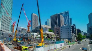 A timelapse of crane at the under construction in Tokyo wide shot. High quality 4k footage. Minato district Azabu Tokyo Japan 06.28.2022 It is center of the city in Tokyo. 