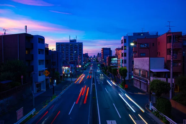 A traffic jam at the street in Setagaya Tokyo at dusk wide shot. High quality photo. Setagaya district Tokyo Japan 06.28.2022 Here is downtown street in Tokyo.