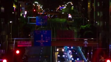 A night timelapse of the traffic jam at the urban street in Tokyo long shot. High quality 4k footage. Setagaya district Tokyo Japan 06.29.2022 Here is a downtown street in Tokyo
