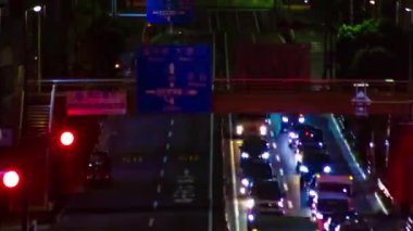 A night timelapse of the traffic jam at the urban street in Tokyo long shot. High quality 4k footage. Setagaya district Tokyo Japan 06.29.2022 Here is a downtown street in Tokyo