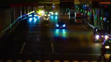 A night timelapse of the traffic jam under the highway in Tokyo long shot. Setagaya district Tokyo Japan 07.11.2022 Here is a downtown street in Tokyo. High quality 4k footage