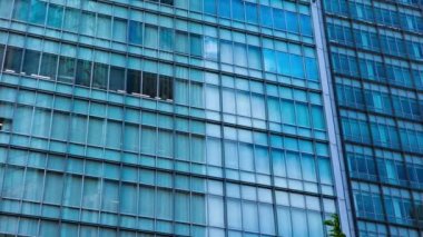 A timelapse of cloud at the building in the business town long shot panning. High quality 4k footage. Nakano district Nakanosakaue Tokyo Japan 07.20.2022 Here is a center of the city in Tokyo. 