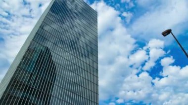 A timelapse of cloud at the building in the business town wide shot. High quality 4k footage. Nakano district Nakanosakaue Tokyo Japan 07.20.2022 Here is a center of the city in Tokyo. 