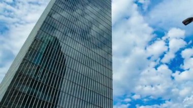 A timelapse of cloud at the building in the business town wide shot panning. High quality 4k footage. Nakano district Nakanosakaue Tokyo Japan 07.20.2022 Here is a center of the city in Tokyo. 