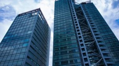 A timelapse of cloud at the building in the business town wide shot tilt. High quality 4k footage. Nakano district Nakanosakaue Tokyo Japan 07.20.2022 Here is a center of the city in Tokyo. 