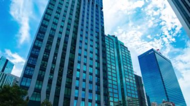 A timelapse of cloud at the building in the business town wide shot tilt. High quality 4k footage. Nakano district Nakanosakaue Tokyo Japan 07.20.2022 Here is a center of the city in Tokyo. 