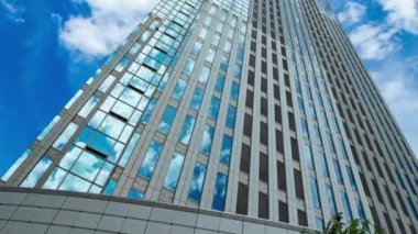 A timelapse of cloud at the building in the business town wide shot panning. High quality 4k footage. Nakano district Nakanosakaue Tokyo Japan 07.20.2022 Here is a center of the city in Tokyo. 