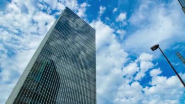 A timelapse of cloud at the building in the business town wide shot tilt. High quality 4k footage. Nakano district Nakanosakaue Tokyo Japan 07.20.2022 Here is a center of the city in Tokyo. 