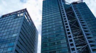 A timelapse of cloud at the building in the business town wide shot zoom. High quality 4k footage. Nakano district Nakanosakaue Tokyo Japan 07.20.2022 Here is a center of the city in Tokyo. 