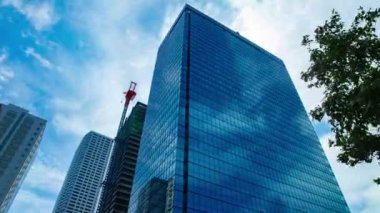 A timelapse of cloud at the building in the business town wide shot zoom. High quality 4k footage. Nakano district Nakanosakaue Tokyo Japan 07.20.2022 Here is a center of the city in Tokyo. 