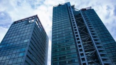 A timelapse of cloud at the building in the business town wide shot zoom. High quality 4k footage. Nakano district Nakanosakaue Tokyo Japan 07.20.2022 Here is a center of the city in Tokyo. 