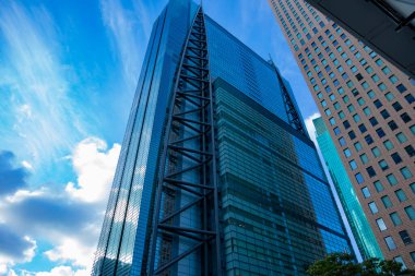 A cloud reflecting the building in the business town wide shot. High quality photo. Minato district Shiodome Tokyo Japan 07.25.2022 Here is a center of the city in Tokyo. 