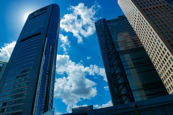 A cloud reflecting the building in the business town wide shot. High quality photo. Minato district Shiodome Tokyo Japan 07.25.2022 Here is a center of the city in Tokyo.