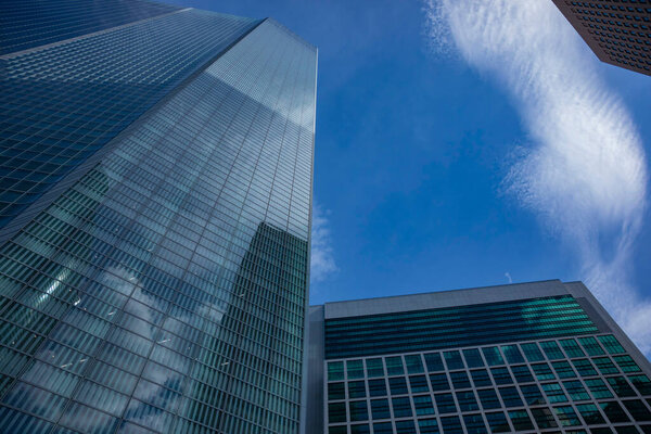 A cloud reflecting the building in the business town wide shot. High quality photo. Minato district Shiodome Tokyo Japan 07.25.2022 Here is a center of the city in Tokyo. 