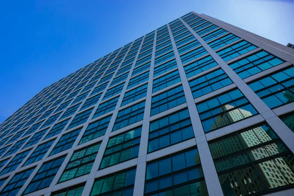 A cloud reflecting the building in the business town wide shot. High quality photo. Minato district Shiodome Tokyo Japan 07.25.2022 Here is a center of the city in Tokyo.