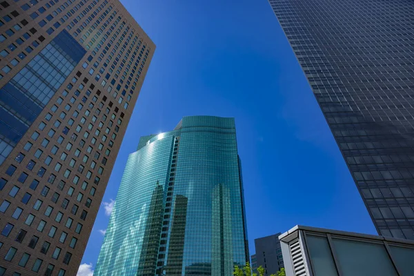 A cloud reflecting the building in the business town wide shot. High quality photo. Minato district Shiodome Tokyo Japan 07.25.2022 Here is a center of the city in Tokyo.