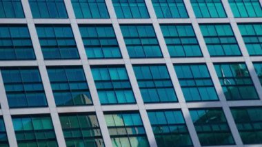 A timelapse of cloud reflecting the building in the business town long shot. High quality 4k footage. Minato district Shiodome Tokyo Japan 07.25.2022 Here is a center of the city in Tokyo. 