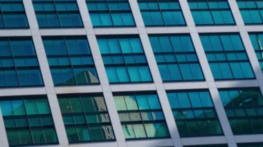 A timelapse of cloud reflecting the building in the business town long shot panning. High quality 4k footage. Minato district Shiodome Tokyo Japan 07.25.2022 Here is a center of the city in Tokyo. 