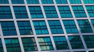 A timelapse of cloud reflecting the building in the business town long shot tilt. High quality 4k footage. Minato district Shiodome Tokyo Japan 07.25.2022 Here is a center of the city in Tokyo. 
