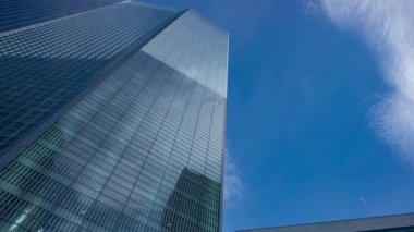 A timelapse of cloud reflecting the building in the business town wide shot panning. High quality 4k footage. Minato district Shiodome Tokyo Japan 07.25.2022 Here is a center of the city in Tokyo. 