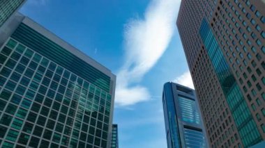 A timelapse of cloud reflecting the building in the business town wide shot zoom. High quality 4k footage. Minato district Shiodome Tokyo Japan 07.25.2022 Here is a center of the city in Tokyo. 